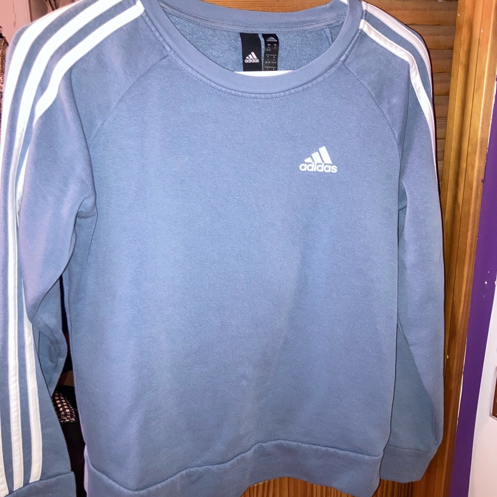 Adidas Women’s Essential 3 Strip Fleece Crewneck Sweatshirt in baby blue.